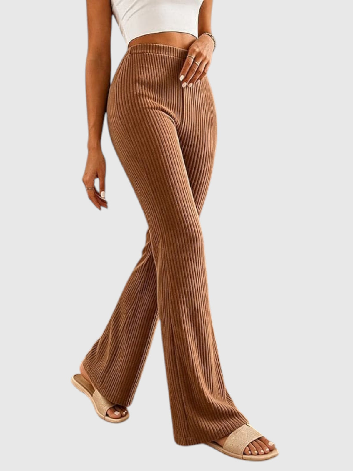 My Store Sophia high-waisted brown ribbed flare pants worn by a model with beige slide sandals
