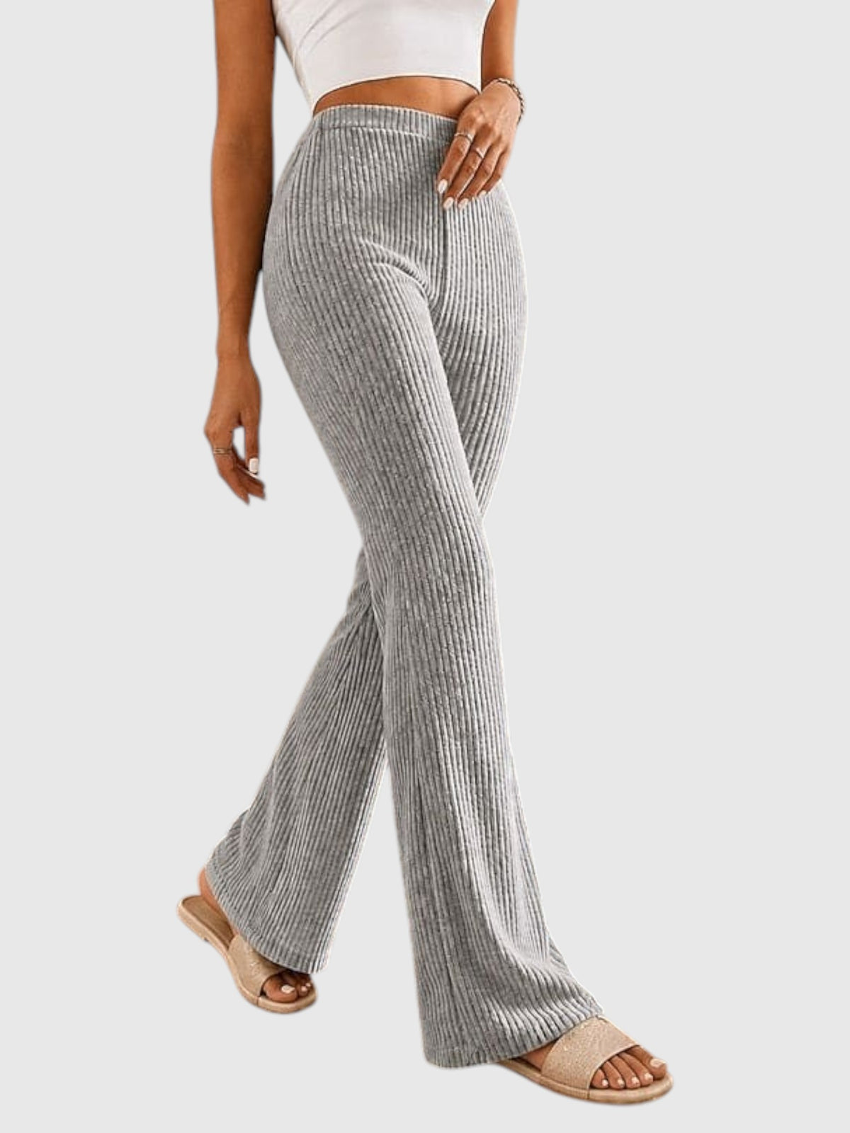My Store Sophia high-waisted grey ribbed flare pants worn by a model with beige slide sandals
