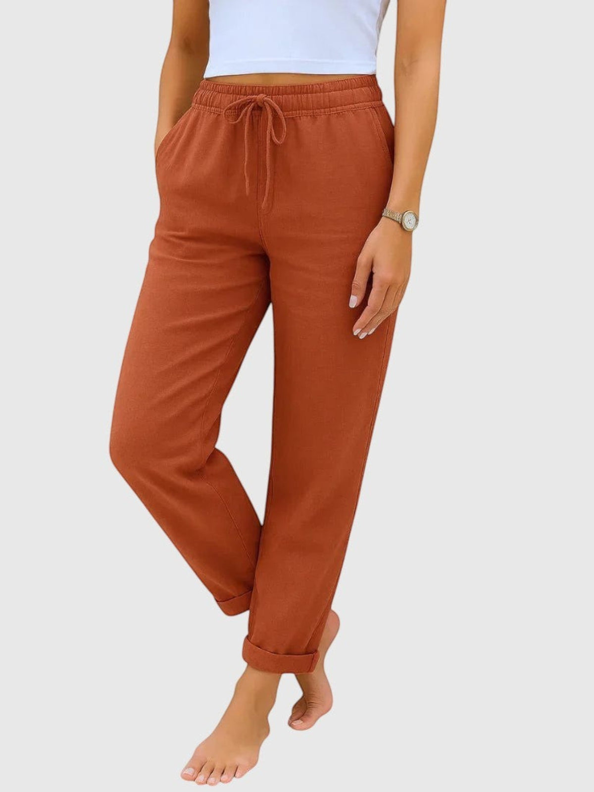 My Store Luna terracotta drawstring pants with elastic waist, relaxed tapered fit, and cuffable hem on a model