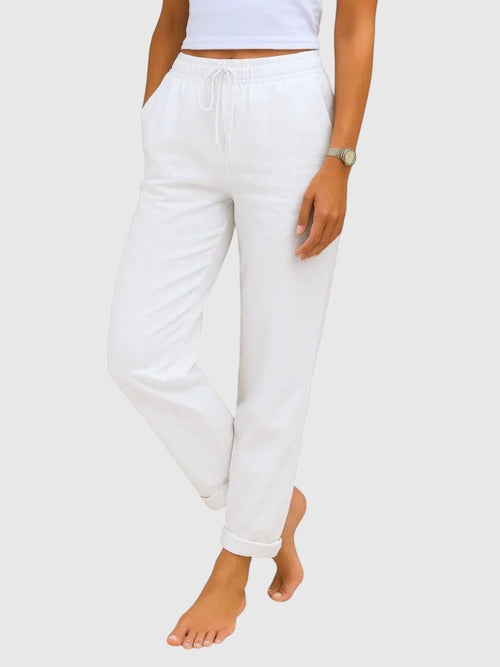 My Store Luna white drawstring pants with elastic waistband and relaxed tapered fit worn by a woman